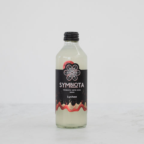 bottle of lychee kefir soda by symbiota