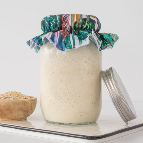 Jar of Sourdough dough rising in warm area